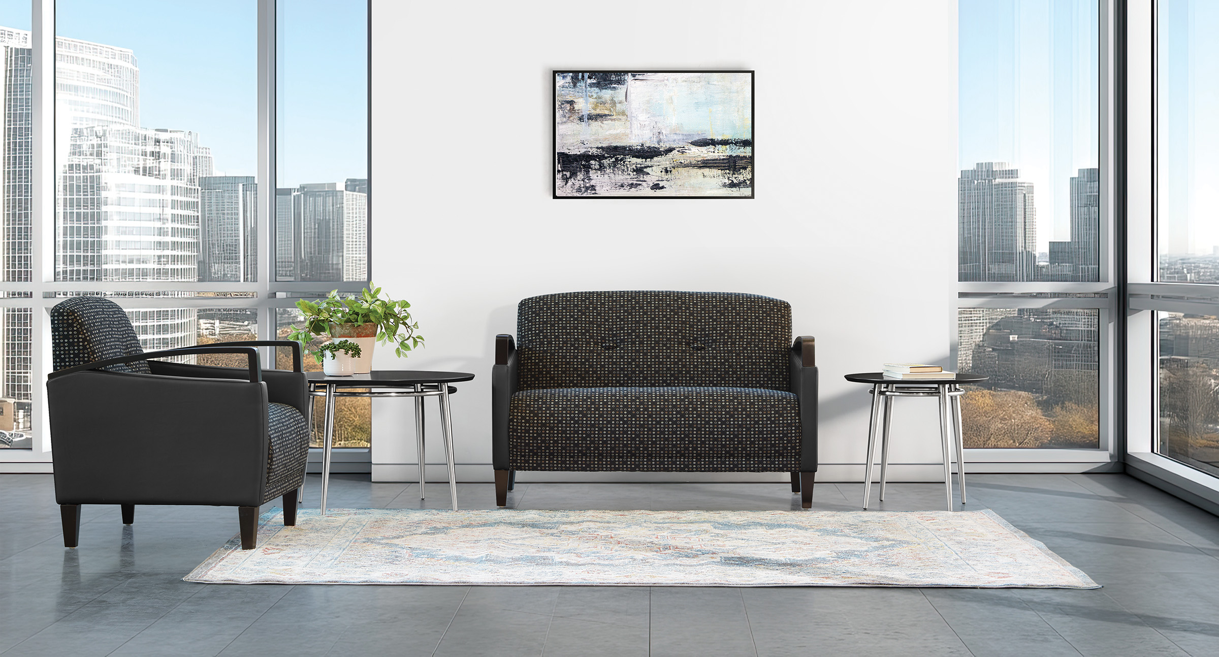 A large, blank framed canvas hangs on a white wall in a modern room with floor-to-ceiling windows offering a panoramic city view, sunlit